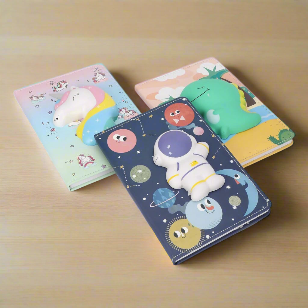 Three colorful notebooks with cartoon character designs on a white background