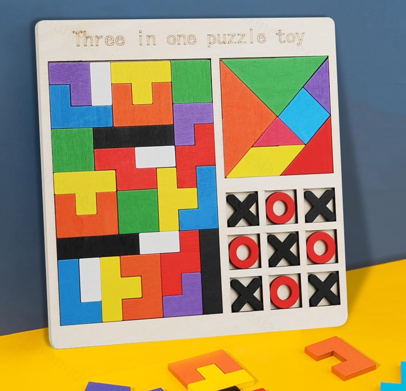 Three-in-one puzzle toy with colorful geometric shapes and tic-tac-toe grid on a blue and yellow background.